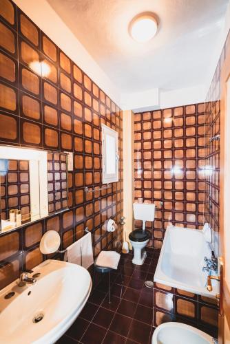 a bathroom with a sink and a toilet and a tub at Grand Hotel Milano in Chianciano Terme