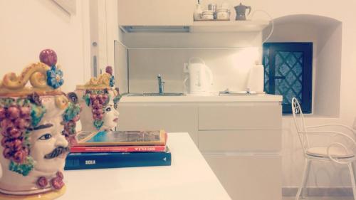a kitchen counter with two vases and books on it at Casa Cleone in Taormina