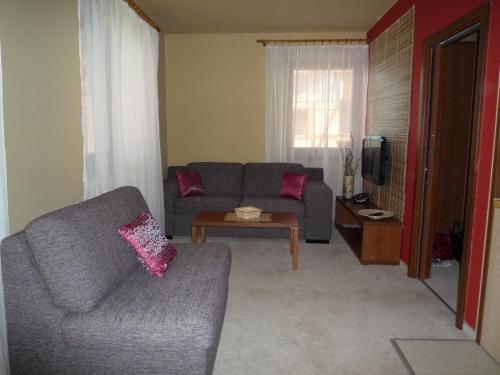 a living room with a couch and a table at Apartman K 306 in Veľká Lomnica