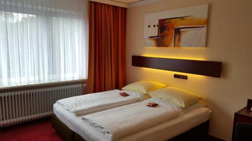 Tempat tidur dalam kamar di Akzent Hotel Oberhausen