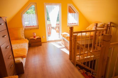 a bedroom with two bunk beds and a staircase at Domki Zacisze in Ostrowo