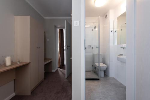 a bathroom with a toilet and a sink at Biały Gościniec in Ciechanów