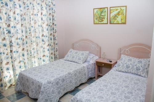 Ένα ή περισσότερα κρεβάτια σε δωμάτιο στο pension hernandez