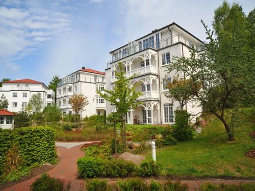 un gran edificio blanco con un jardín delante de él en Ferienwohnungen auf Rügen, en Binz