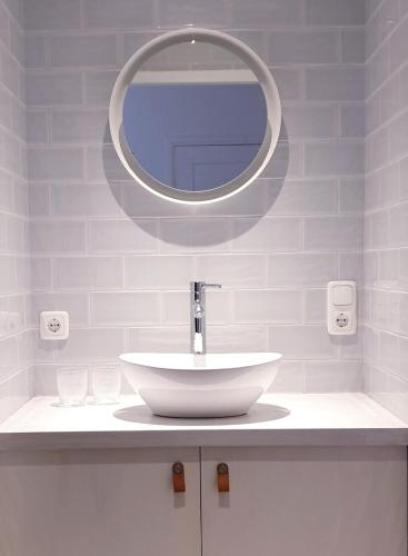 a bathroom with a white sink and a mirror at Appartement Plek in Holten in Holten