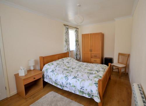 a bedroom with a bed and a table and a chair at The Willows in Rookley