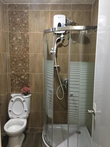 a bathroom with a toilet and a shower at Mirasol Residences in Daet