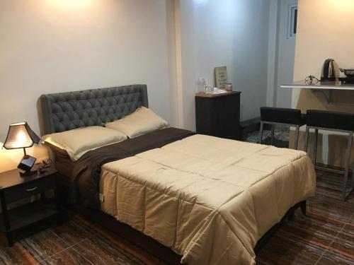 a hotel room with a bed and a table at Mirasol Residences in Daet