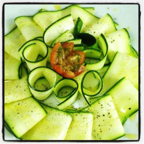 a plate filled with cucumbers and a tomato and sidx sidx sidx at Masseria Torre Del Diamante in Torre Canne