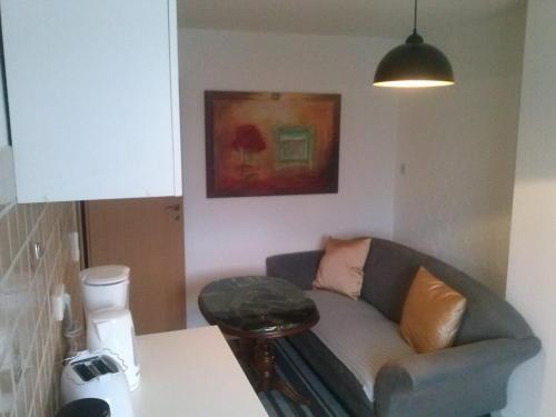 a living room with a couch and a table at Ferienwohnung Konrad - nahe Chemnitz in Limbach - Oberfrohna