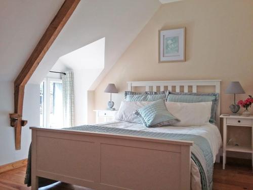 a bedroom with a large bed in a attic at Le Grenier, La Vieille Ferme in Ruffiac