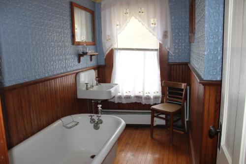 uma casa de banho com uma banheira e um lavatório em The Sterling Inn em Caratunk