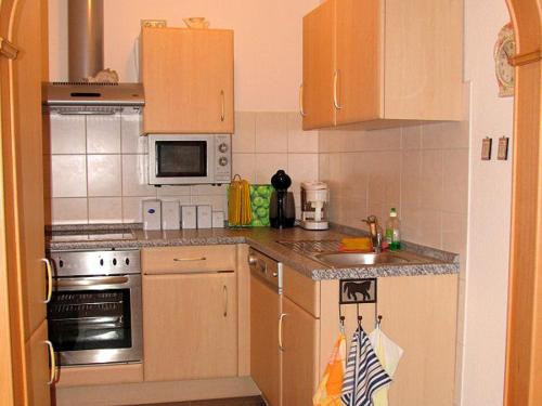 a kitchen with a sink and a stove top oven at Jenny´s Ferienwohnungen in Bad Salzungen