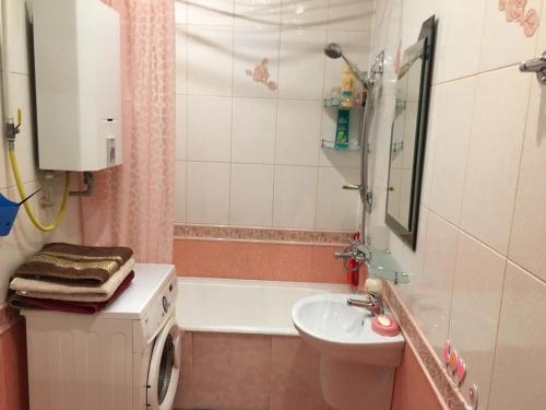 a bathroom with a sink and a tub and a toilet at Великолепное расположение! Центр ! in Brest