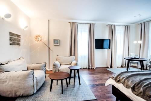 a living room with a bed and a couch at Boutique Hotel Boškinac in Novalja
