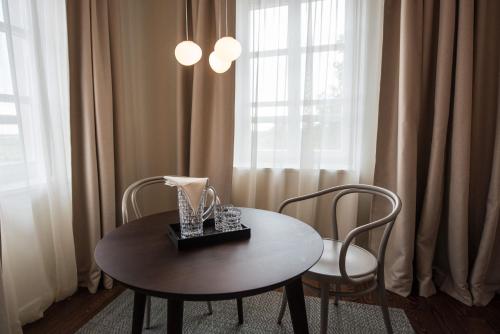 a table and two chairs in front of a window at Boutique Hotel Boškinac in Novalja