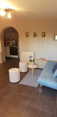 - un salon avec un canapé bleu et une table dans l'établissement Apartment Borna, à Pazin