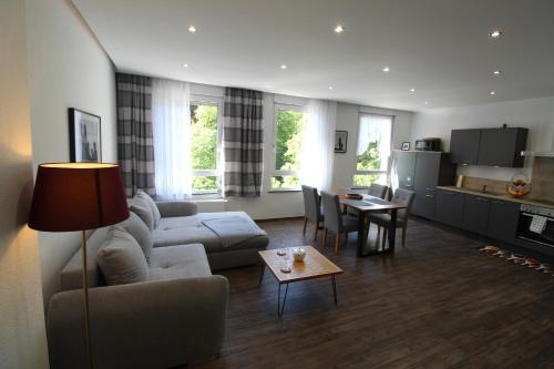 a living room with a couch and a table at Palatium Bad Ems in Bad Ems