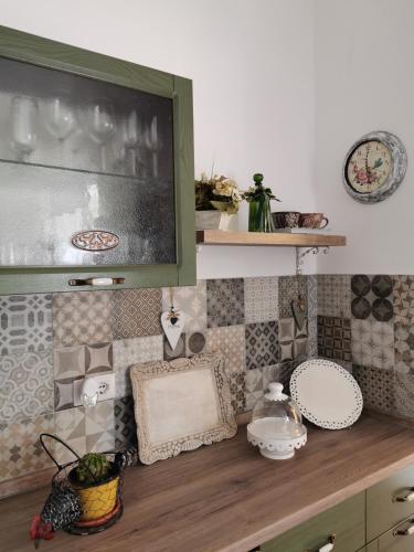 a kitchen with a counter top with plates and dishes at Affittacamere Alisso in Olbia