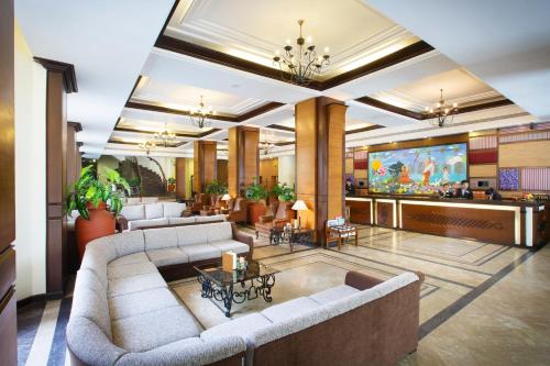 a living room with couches and a tv in a lobby at Royal Singi Hotel in Kathmandu