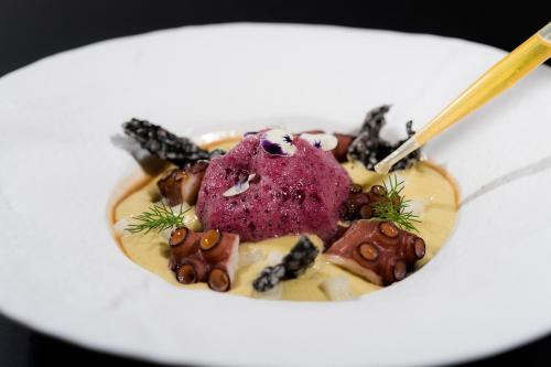 a white plate of food with a purple dessert at Boutique Hotel Boškinac in Novalja