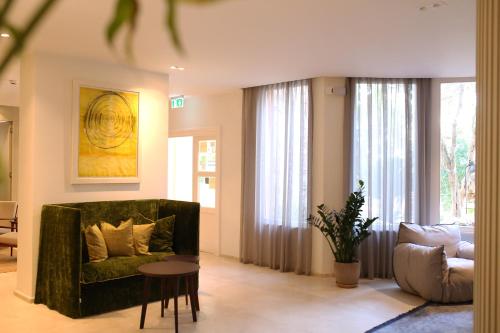 a living room with a couch and a table at Boutique Hotel Boškinac in Novalja