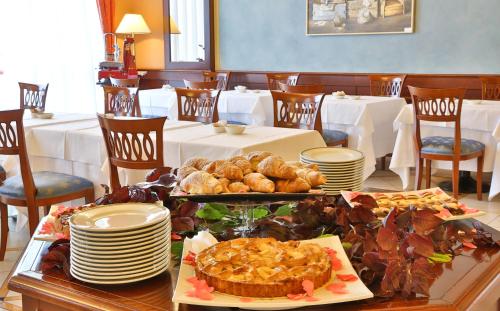 a table with plates and food on top at Best Western Classic Hotel in Reggio Emilia