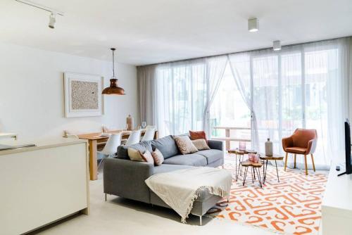 a living room with a couch and a table at Marina Puente Romano - Groundfloor - 3 Bedrooms in Marbella