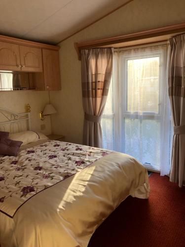 a bedroom with a large bed and a window at Lyndhurst in Dunoon