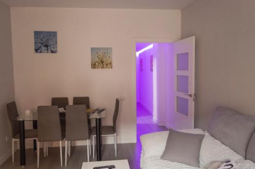 a living room with a couch and a table with a purple door at Estepeña in Talavera de la Reina