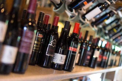 a bunch of wine bottles sitting on a shelf at Aparthotel Pfeffermühle in Ramsau am Dachstein