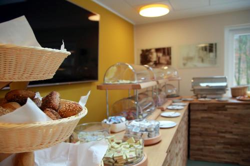 a buffet with baskets of pastries on a counter at Hotel Grünwalde in Halle Westfalen