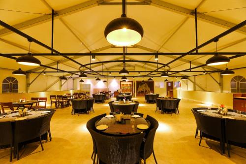 a restaurant with tables and chairs in a tent at Annai Resorts & Spa in Kanyakumari