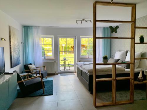 a bedroom with a bunk bed and a living room at Appartementanlage Lancken-Granitz in Lancken-Granitz