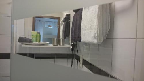 a bathroom with a mirror and a sink at K82 studio HOTEL relax&work in Kirchentellinsfurt