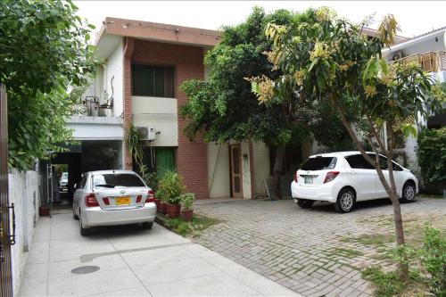 two cars parked in front of a house at Tulip guesthouse in Islamabad