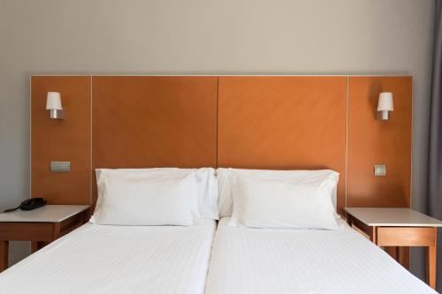 Ένα ή περισσότερα κρεβάτια σε δωμάτιο στο Hotel El Palmeral