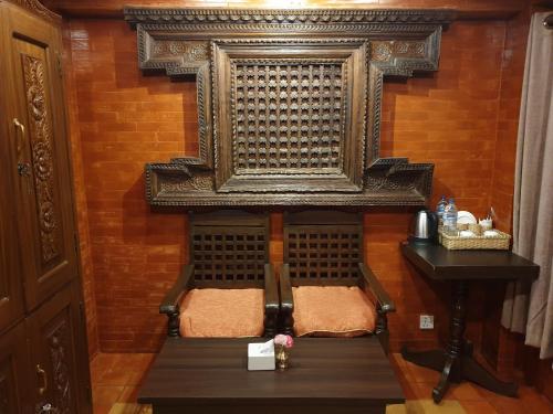 a room with a chair and a table in a room at Temple House in Kathmandu