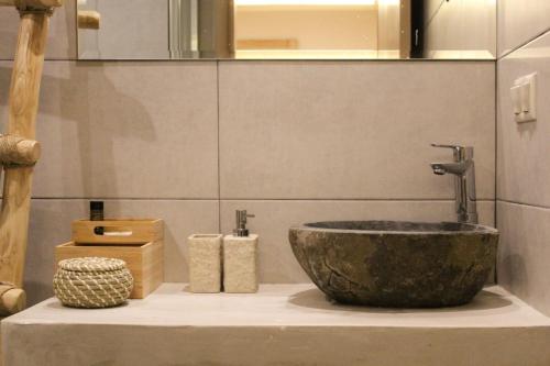 a white sink sitting next to a large mirror at Ederlezi Boutique Hotel in Athens