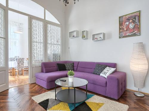 a purple couch in a living room with a table at Apartment Silvia by Interhome in Pula