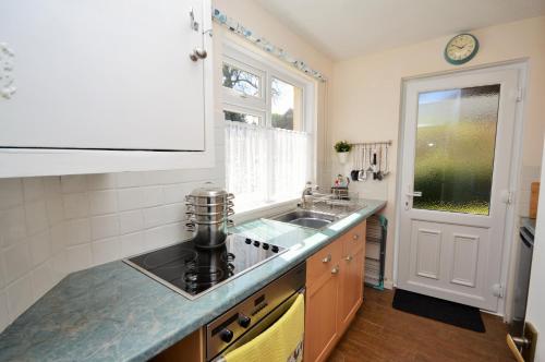 a kitchen with a sink and a counter top at The Willows in Rookley