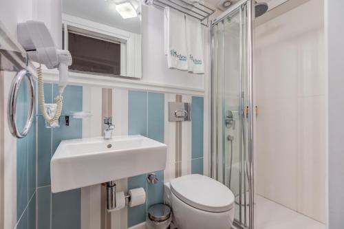 a bathroom with a sink and a toilet and a shower at Ela Tenedos Hotel - Special Category in Bozcaada