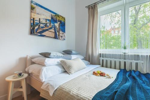 a bedroom with a bed with a plate of fruit on it at P&O Apartments Plac Zbawiciela in Warsaw