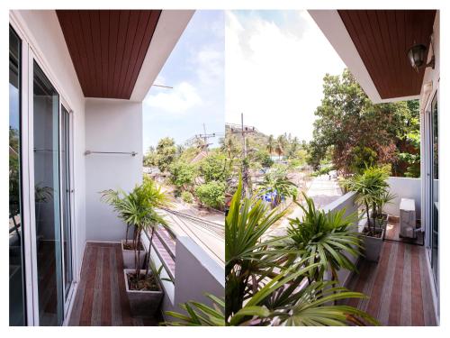 a balcony with plants and a view of a street at Namhasin House in Koh Tao