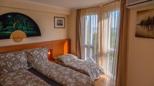 Postel nebo postele na pokoji v ubytování Aart Apartman