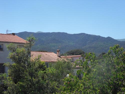 a group of houses with mountains in the background at Chambres d'Hôtes de la Grone in Argelès-sur-Mer