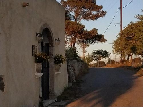 a building with a door on the side of a road at DonQuihotel Chalet in Karvounádhes