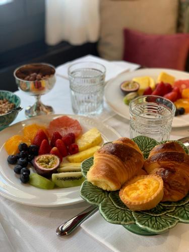 a table with two plates of breakfast food on it at Madama Garden Retreat in Venice