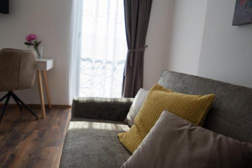 a living room with a couch and a window at SOBE "GALEB" in Vrbnik