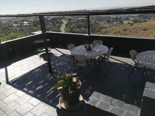 a patio with a table and chairs on a balcony at Arek's Place in Krugersdorp